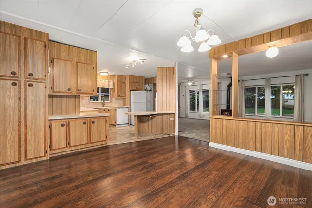 a view of a kitchen with wooden floor and window