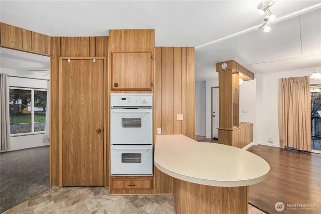 a living room with a white furniture and wooden floor