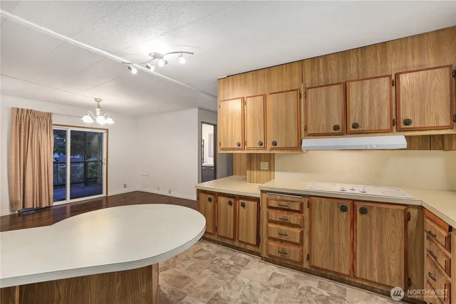 a kitchen with stainless steel appliances granite countertop a sink a stove and cabinets