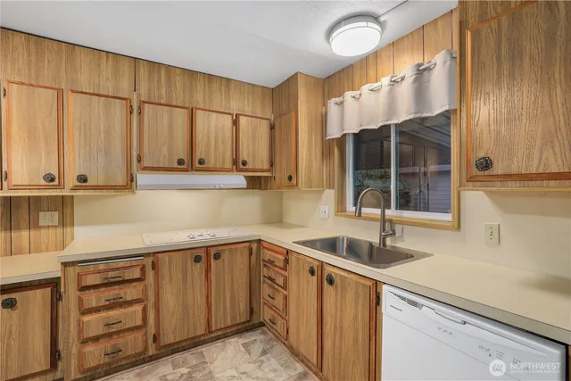 a kitchen with a sink and cabinets