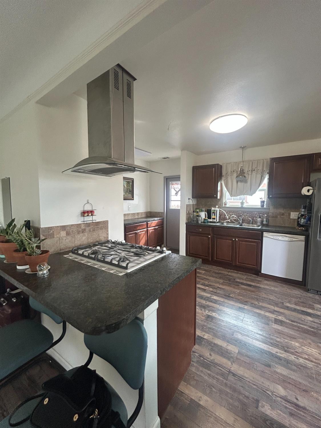 313 East Sacramento Street Coalinga, CA 93210 - Photo 14 of 23 a kitchen with kitchen island a stove and a refrigerator