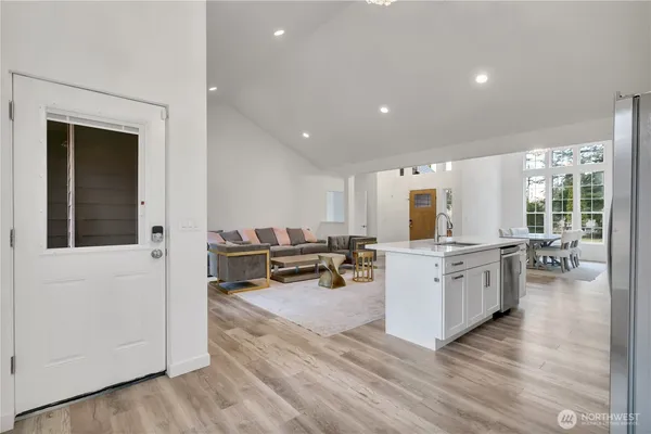 a kitchen with a sink cabinets and wooden floor