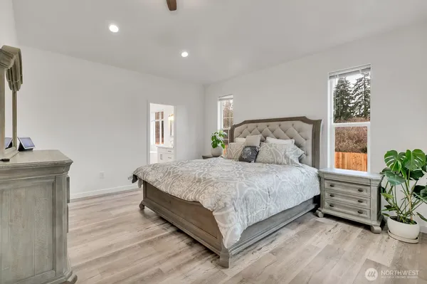 a bedroom with a bed and windows