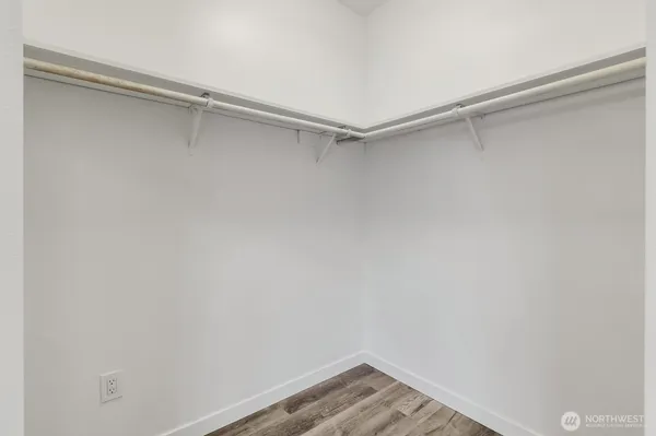 a view of walk in closet with empty racks