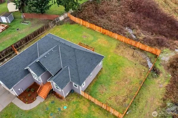 an aerial view of residential houses with outdoor space and swimming pool