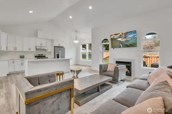 a living room with furniture and a fireplace