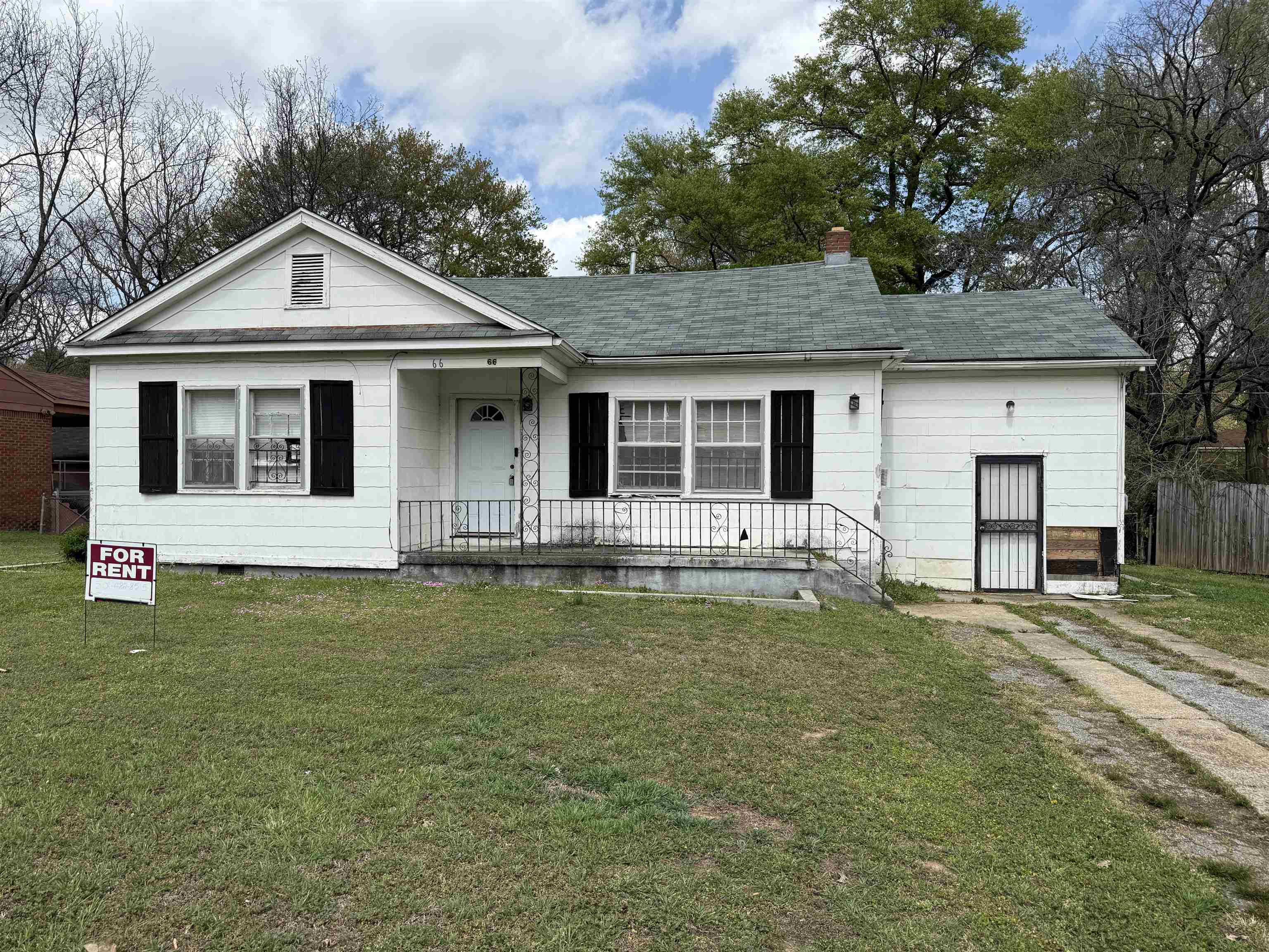 66 East Rollins Road Memphis, TN 38109 - Photo 1 of 31 View of front of house featuring a front lawn, a chimney, and covered porch