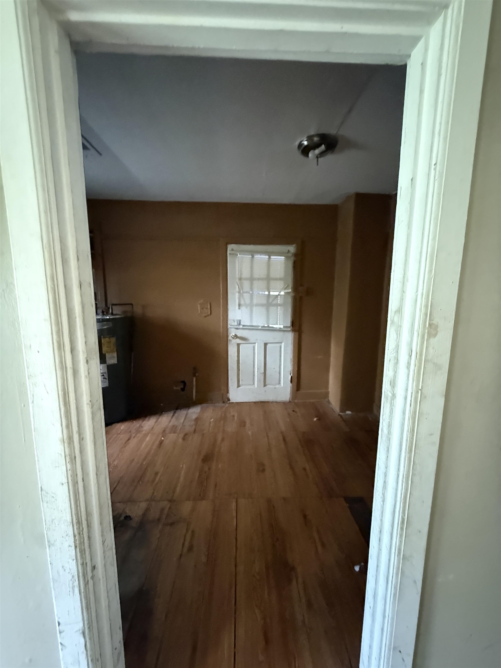66 East Rollins Road Memphis, TN 38109 - Photo 26 of 31 Hallway featuring wood-type flooring and electric water heater