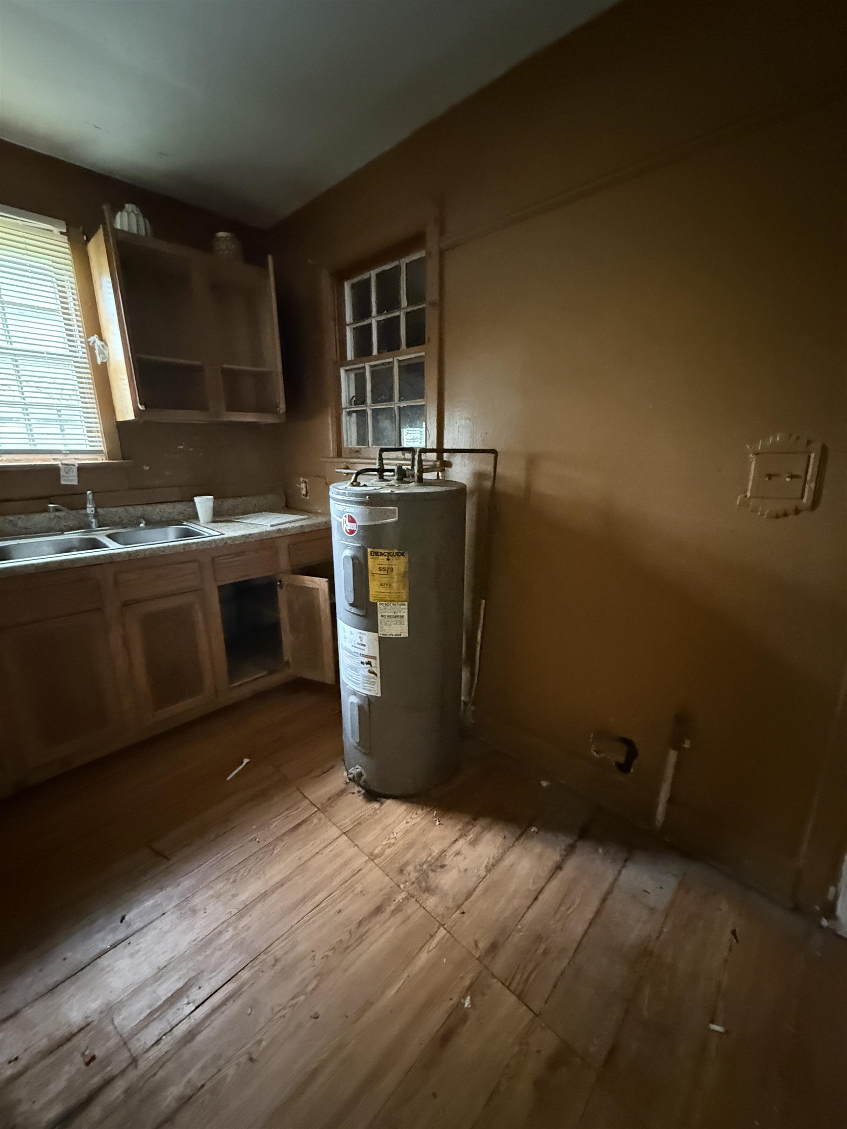 66 East Rollins Road Memphis, TN 38109 - Photo 29 of 31 Kitchen with electric water heater and light wood-style floors
