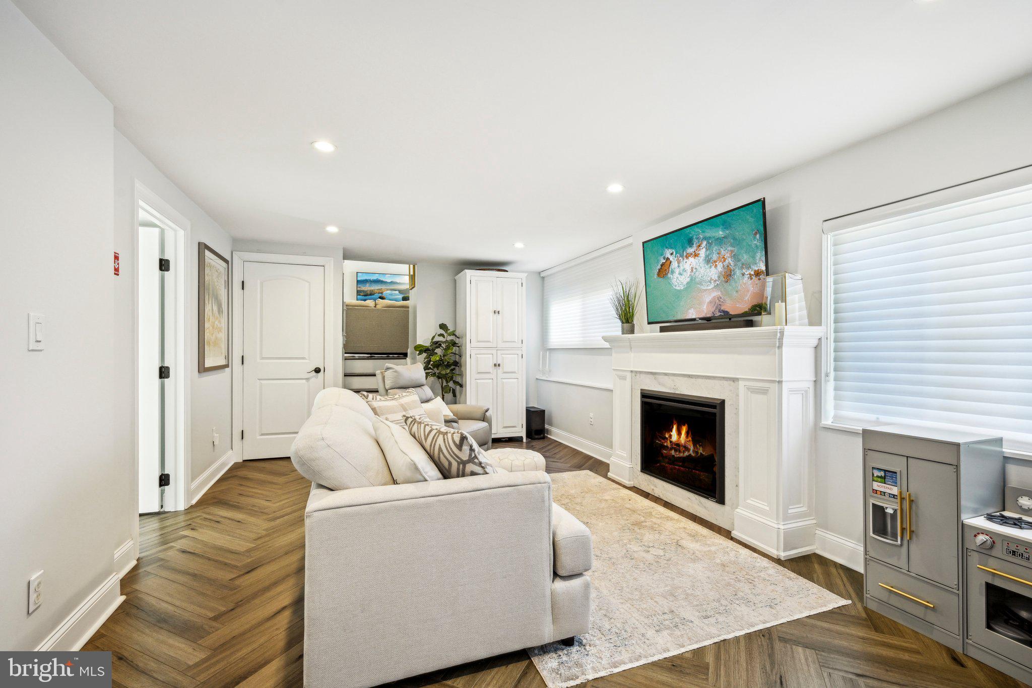 42 Cameo Road Claymont, DE 19703 - Photo 23 of 37 a living room with furniture a fireplace and a flat screen tv