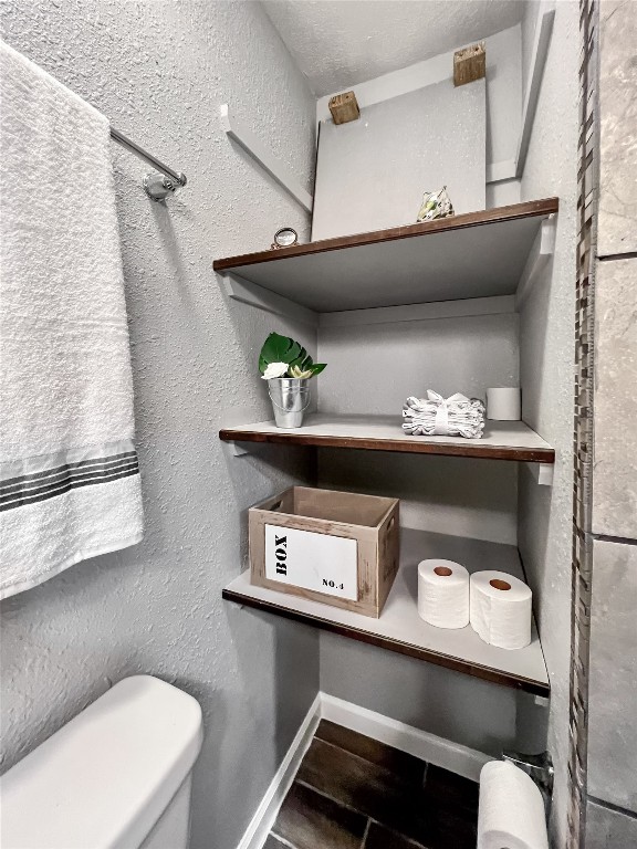 6347 Limestone Street Houston, TX 77092 - Photo 16 of 26 Discover the perfect blend of style and functionality with these sleek storage shelves in the ensuite bath, ideal for keeping your essentials neatly organized and within easy reach.