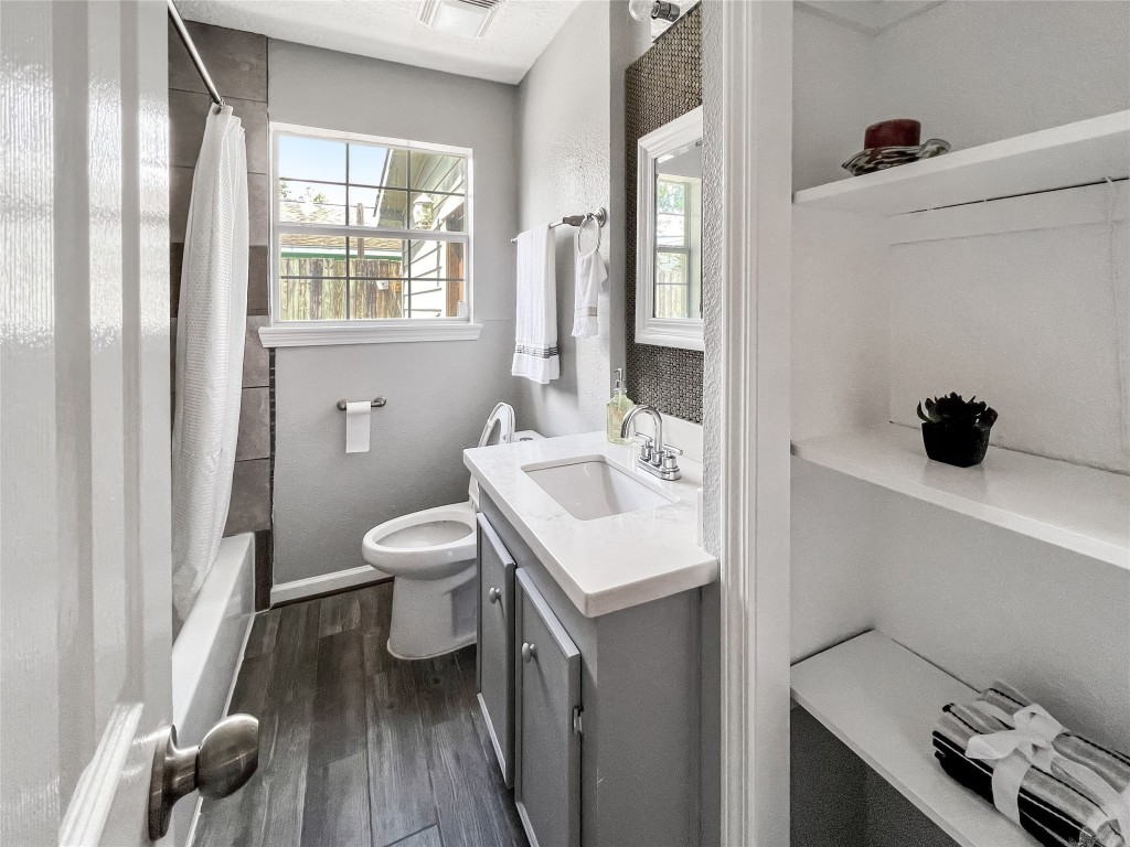 6347 Limestone Street Houston, TX 77092 - Photo 8 of 26 This inviting hall bath features modern fixtures, ample natural light, and elegant storage, creating a perfect blend of style and functionality.