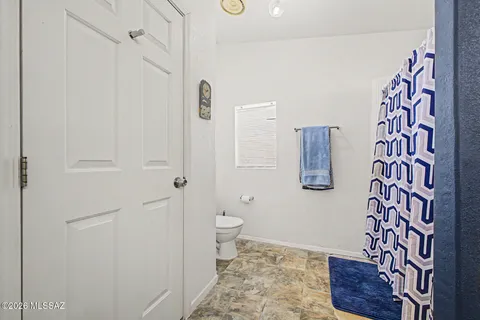 a bathroom with a toilet and shower