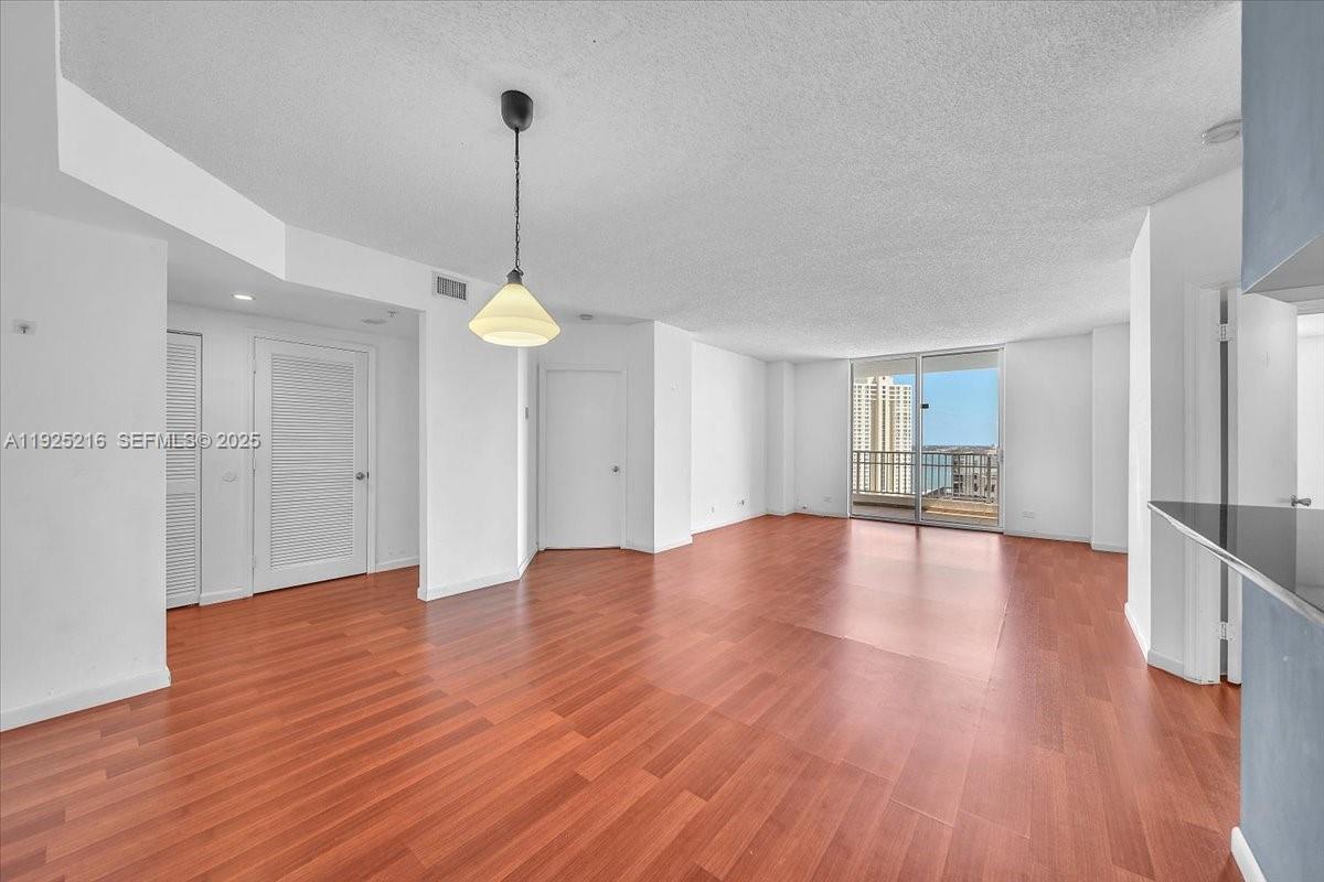 701 Brickell Key Boulevard, Unit 1911 Miami, FL 33131 - Photo 13 of 39 a view of a room with wooden floor and window