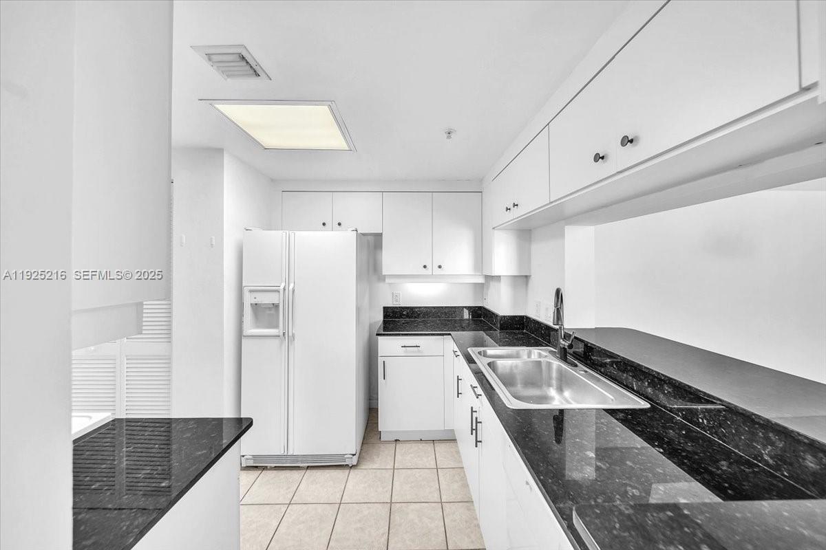 701 Brickell Key Boulevard, Unit 1911 Miami, FL 33131 - Photo 15 of 39 a kitchen with a refrigerator a stove and cabinets