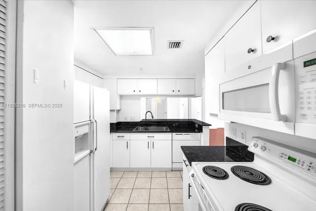 a kitchen with stainless steel appliances a stove a sink and a refrigerator