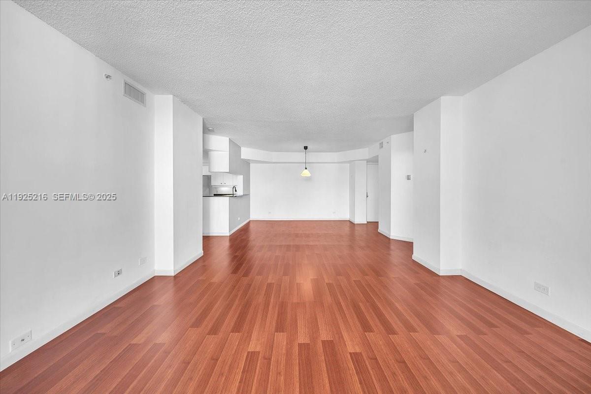 701 Brickell Key Boulevard, Unit 1911 Miami, FL 33131 - Photo 17 of 39 a view of empty room with wooden floor