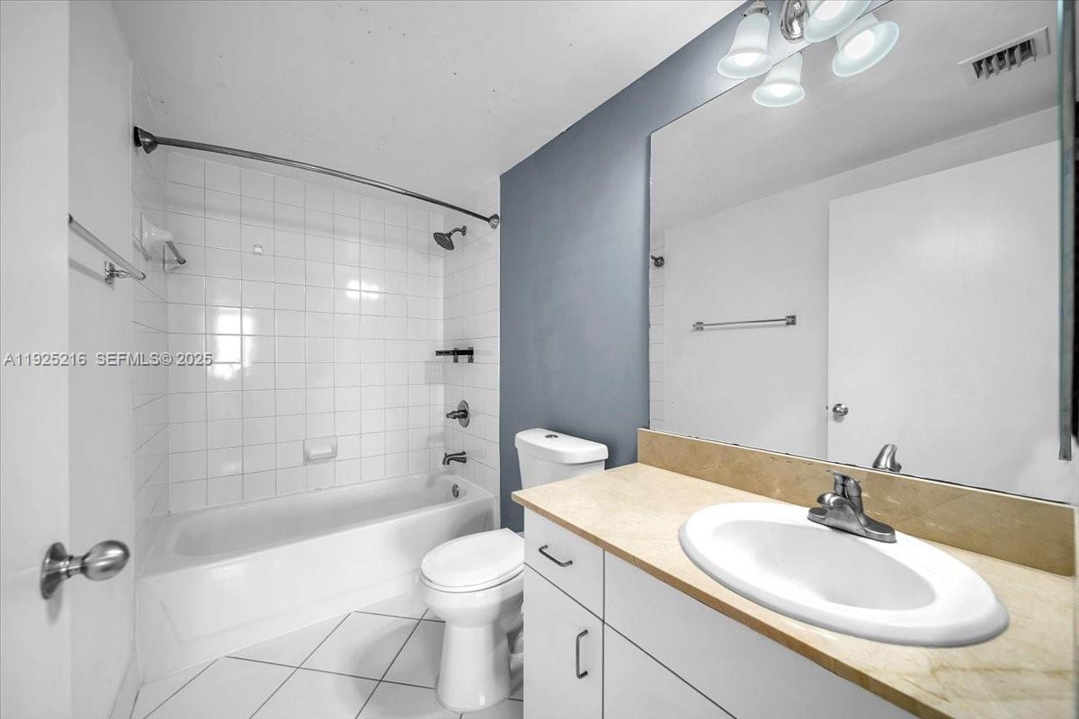 701 Brickell Key Boulevard, Unit 1911 Miami, FL 33131 - Photo 20 of 39 a bathroom with a sink a toilet and shower