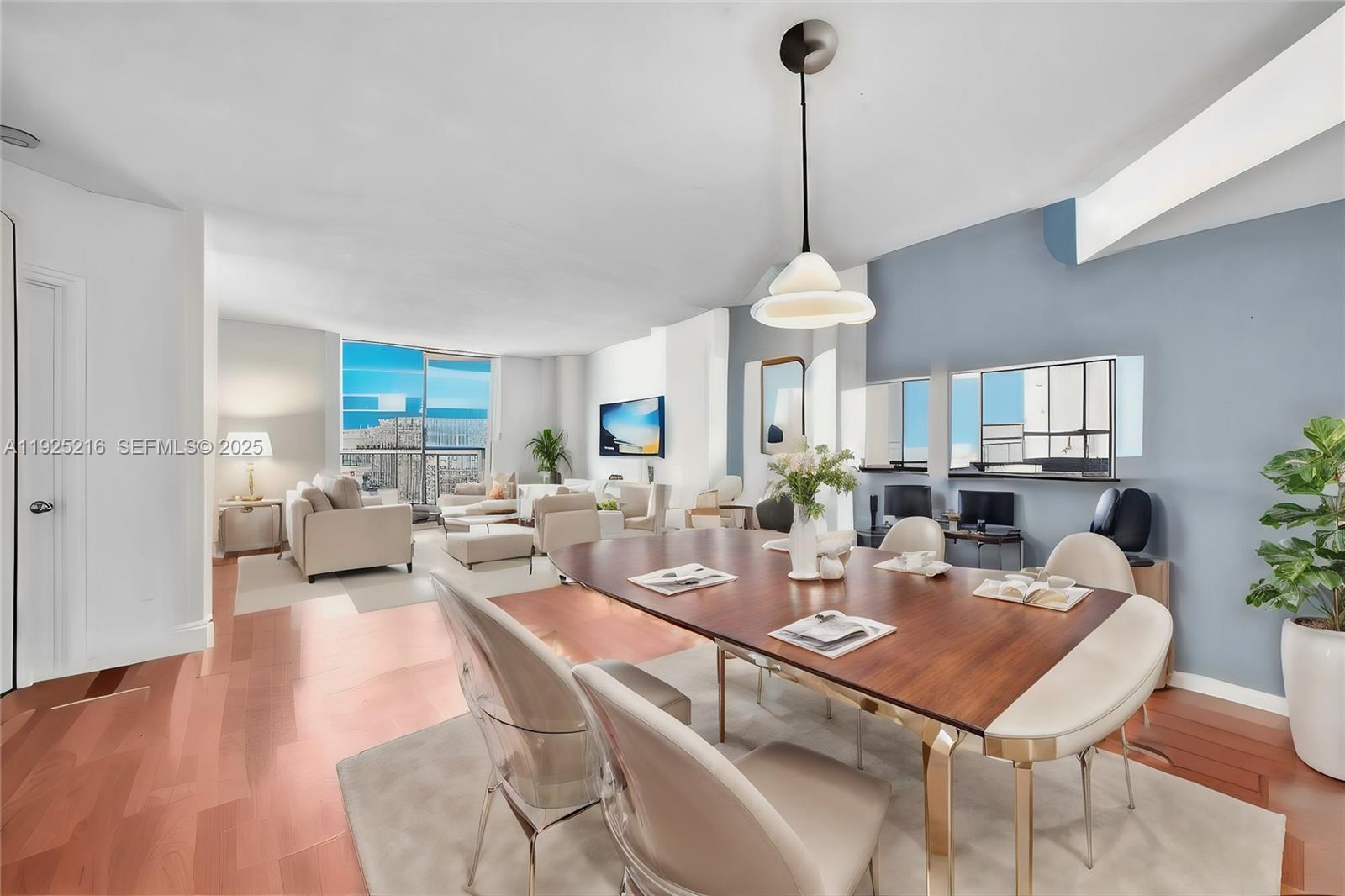 701 Brickell Key Boulevard, Unit 1911 Miami, FL 33131 - Photo 2 of 39 a dining room with furniture a chandelier and wooden floor
