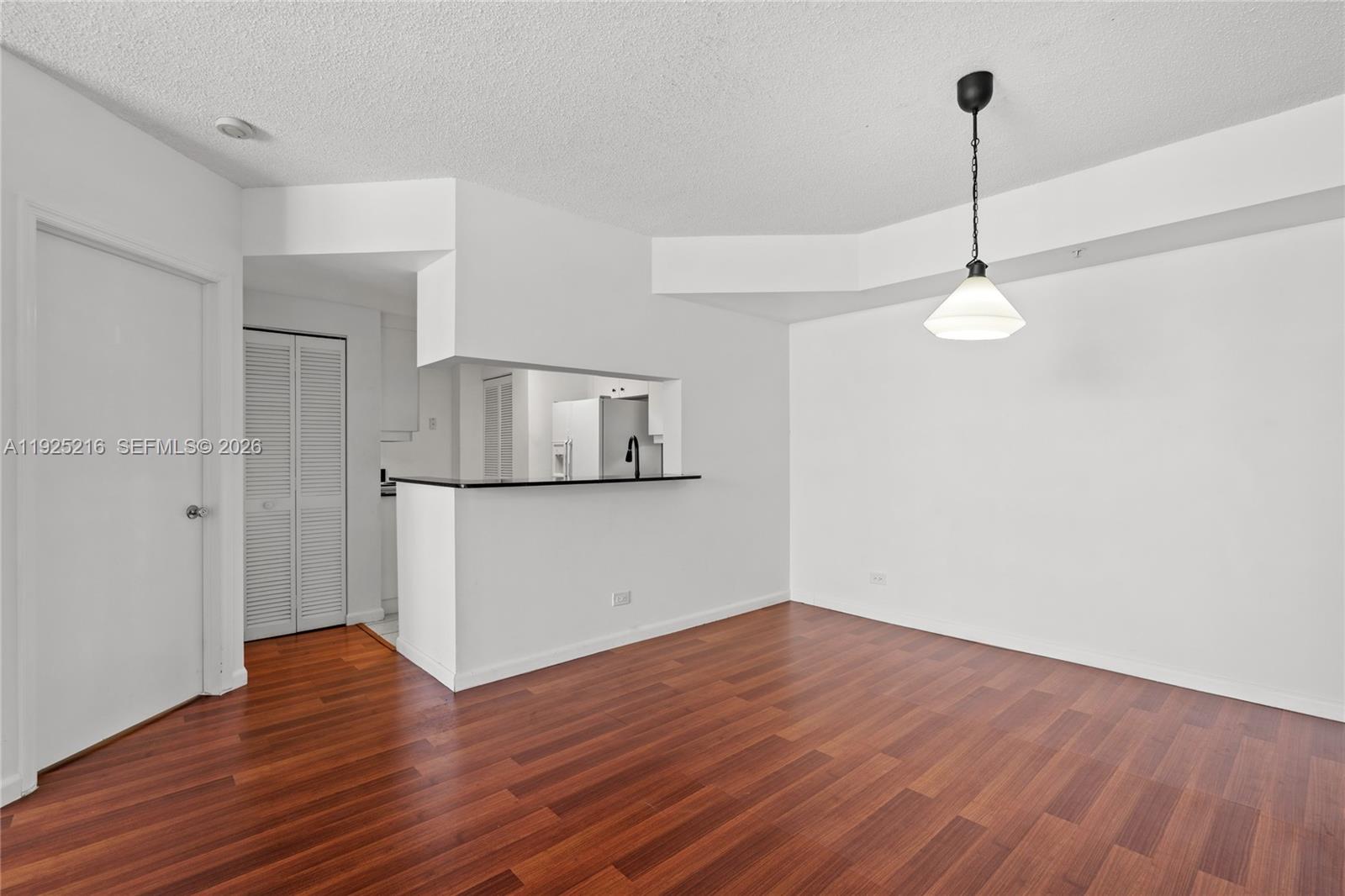 701 Brickell Key Boulevard, Unit 1911 Miami, FL 33131 - Photo 22 of 75 a view of a room with wooden floor and ceiling fan