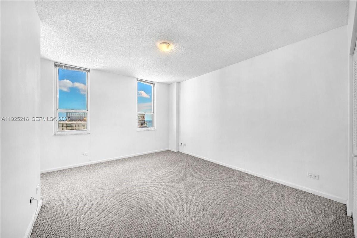 701 Brickell Key Boulevard, Unit 1911 Miami, FL 33131 - Photo 23 of 39 an empty room with windows