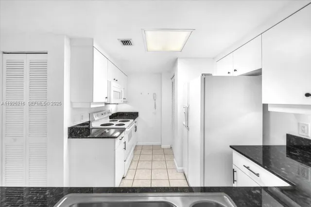 a kitchen with stainless steel appliances granite countertop a stove and a refrigerator