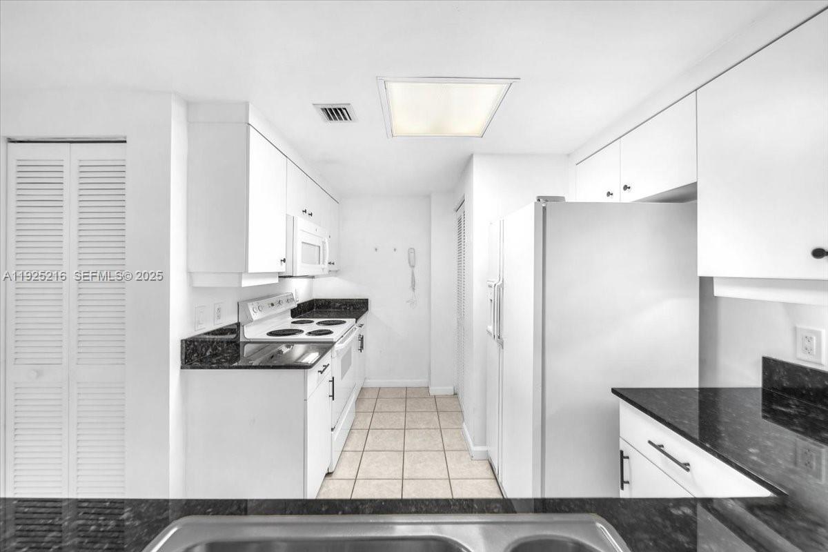 701 Brickell Key Boulevard, Unit 1911 Miami, FL 33131 - Photo 4 of 39 a kitchen with stainless steel appliances granite countertop a stove and a refrigerator