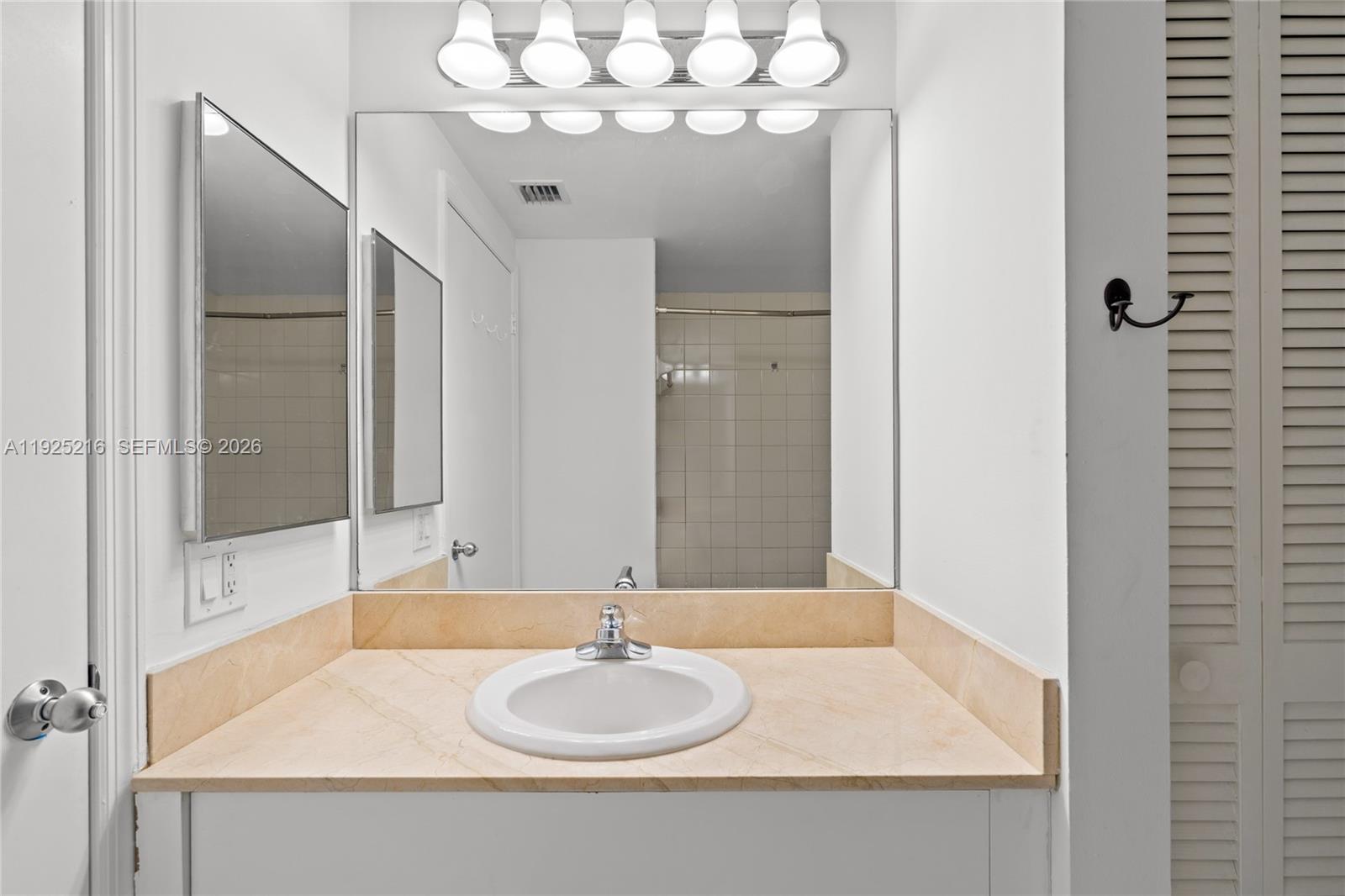 701 Brickell Key Boulevard, Unit 1911 Miami, FL 33131 - Photo 44 of 75 a bathroom with a sink and a mirror