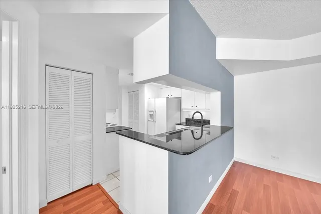 a view of a room with wooden floor and window