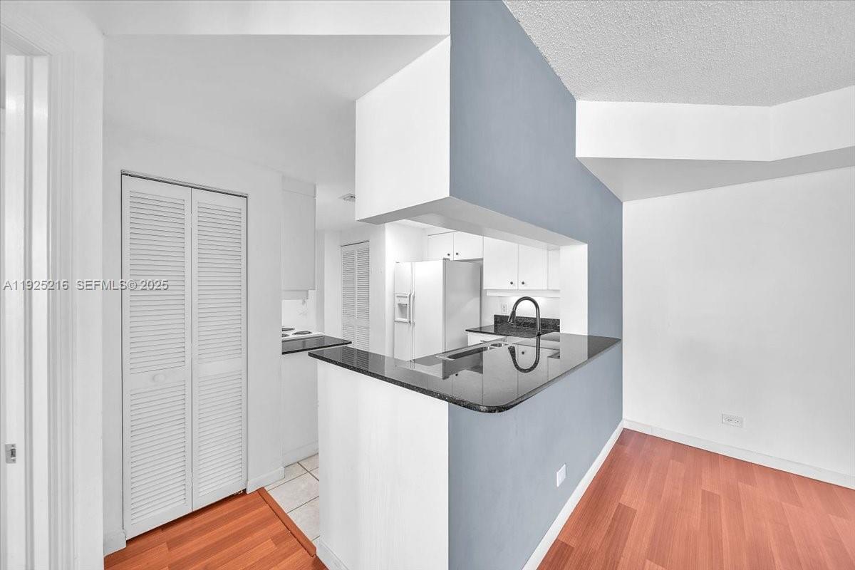 701 Brickell Key Boulevard, Unit 1911 Miami, FL 33131 - Photo 10 of 39 a kitchen with sink and refrigerator