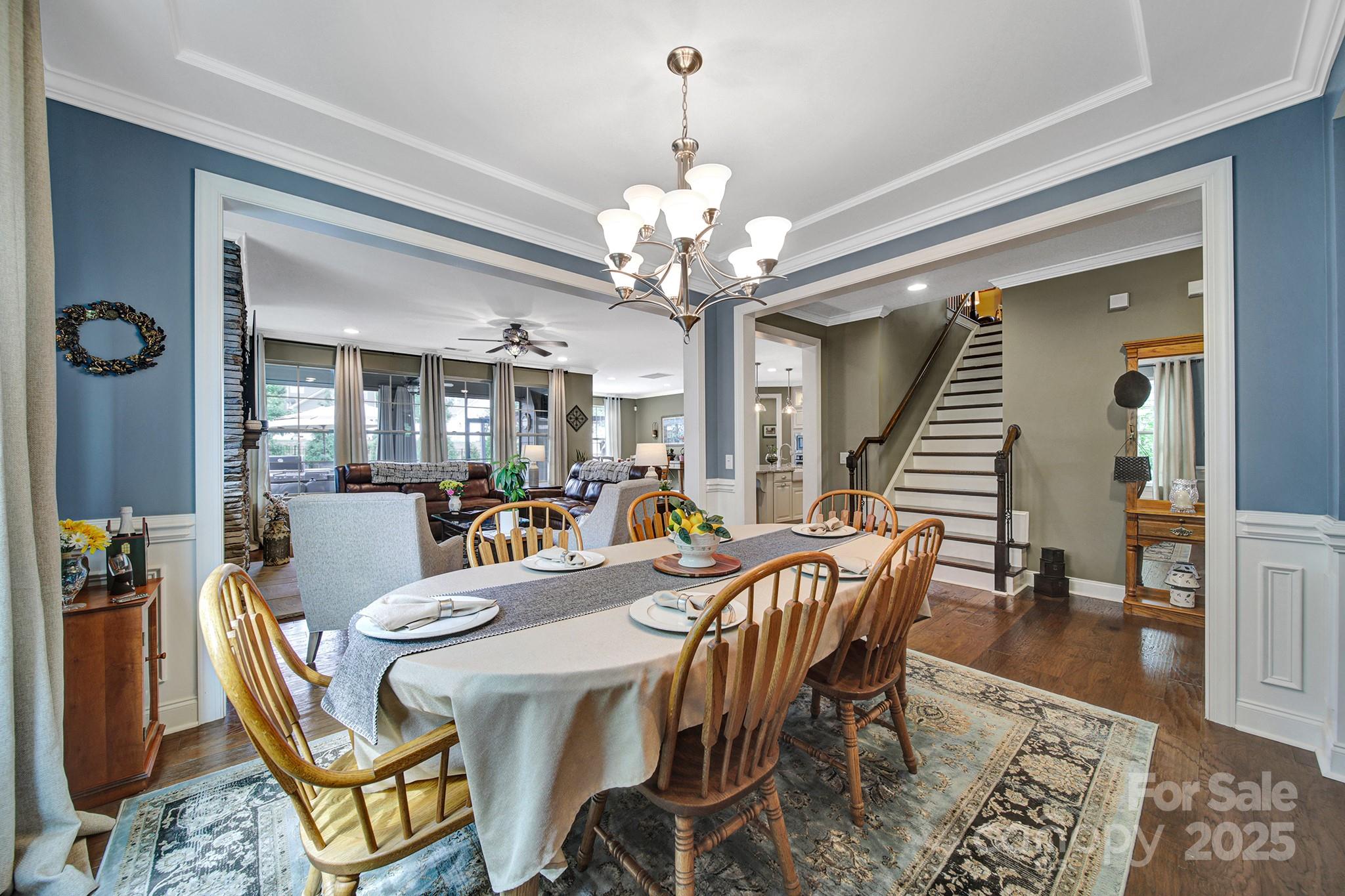 998 Emory Lane Fort Mill, SC 29708 - Photo 12 of 48 a dining room with wooden floor a chandelier a wooden table and chairs