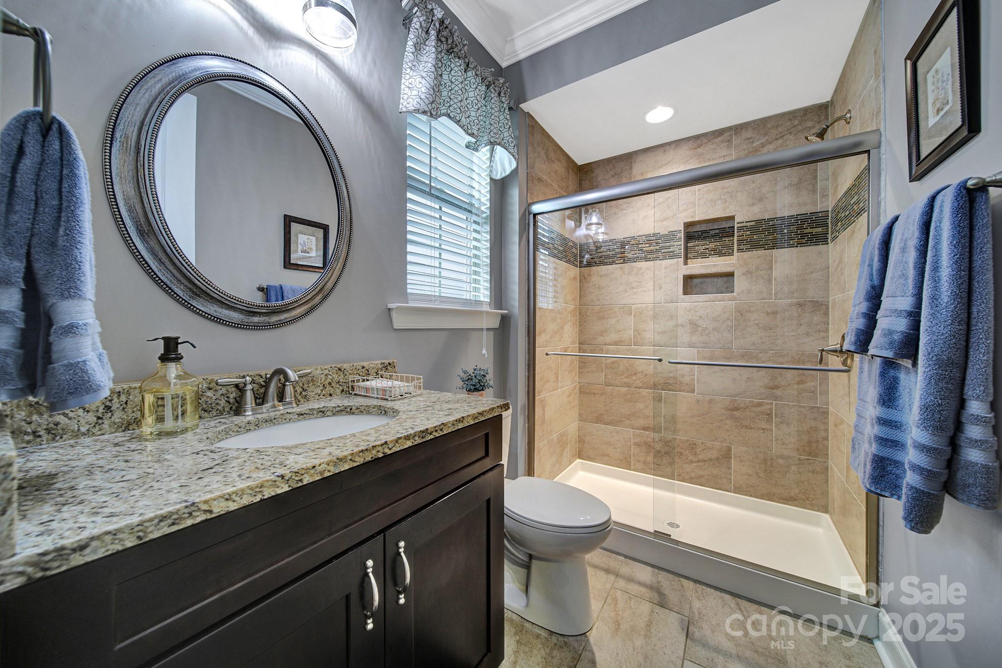 998 Emory Lane Fort Mill, SC 29708 - Photo 18 of 48 a bathroom with a granite countertop sink mirror vanity and toilet