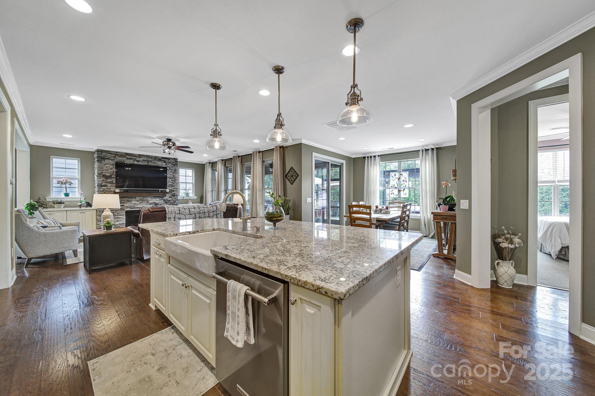 998 Emory Lane Fort Mill, SC 29708 - Photo 7 of 48 a kitchen with stainless steel appliances granite countertop a kitchen island a stove a sink a oven a dining table and chairs
