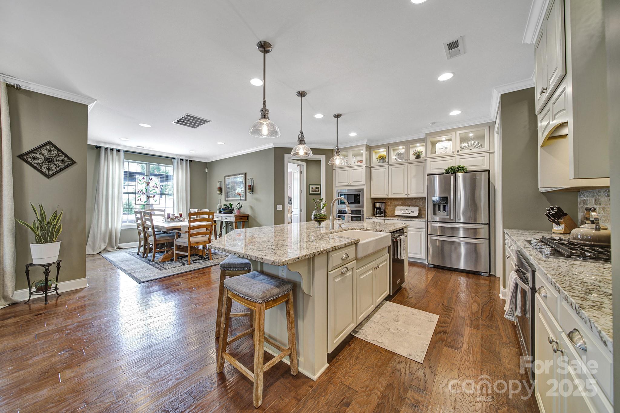 998 Emory Lane Fort Mill, SC 29708 - Photo 8 of 48 a kitchen with granite countertop lots of counter top space stainless steel appliances and wooden floor
