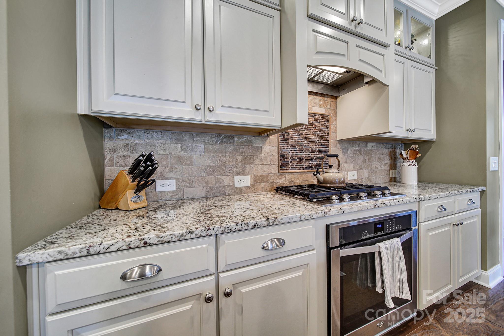 998 Emory Lane Fort Mill, SC 29708 - Photo 9 of 48 a kitchen with stainless steel appliances granite countertop white cabinets and a stove