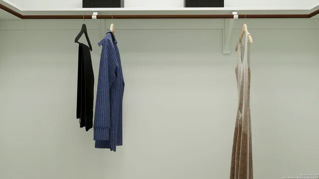 a view of walk in closet with clothes