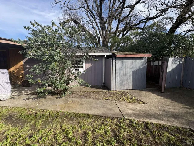 a view of a house with a yard and garage
