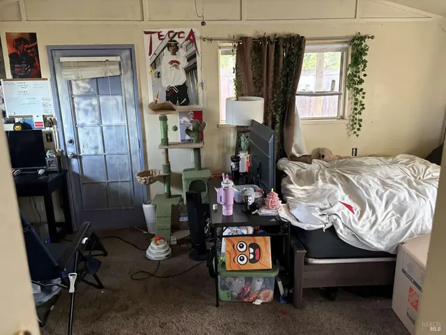 a bed room with a bed and a window