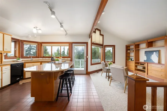 a view of a dining room with furniture large windows and wooden floor