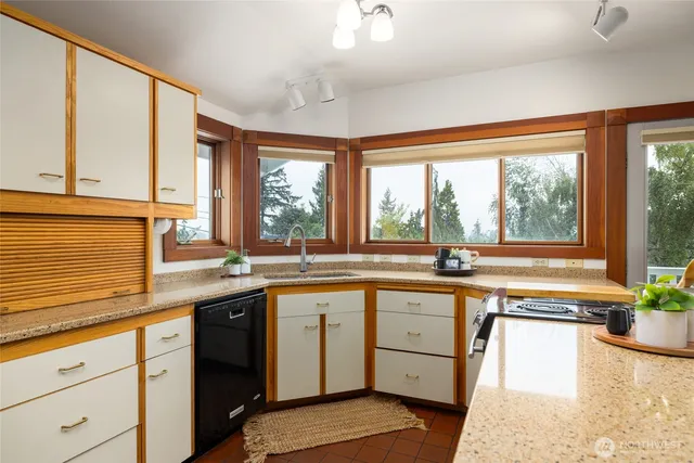 a kitchen with a sink and large window