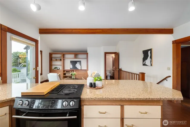 a kitchen with a stove and a white cabinets