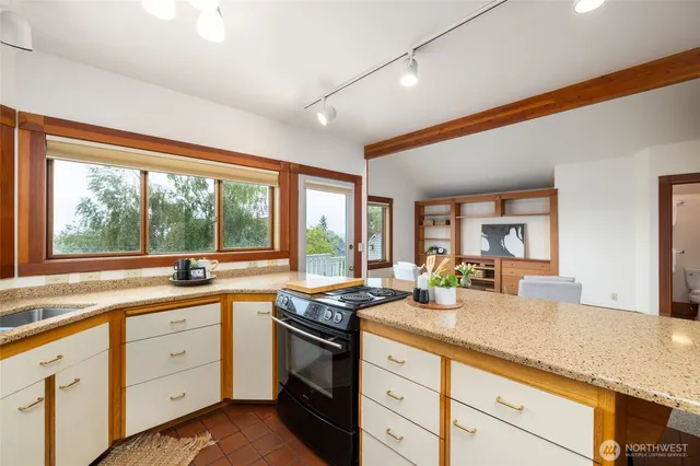 a kitchen with sink attached with living room