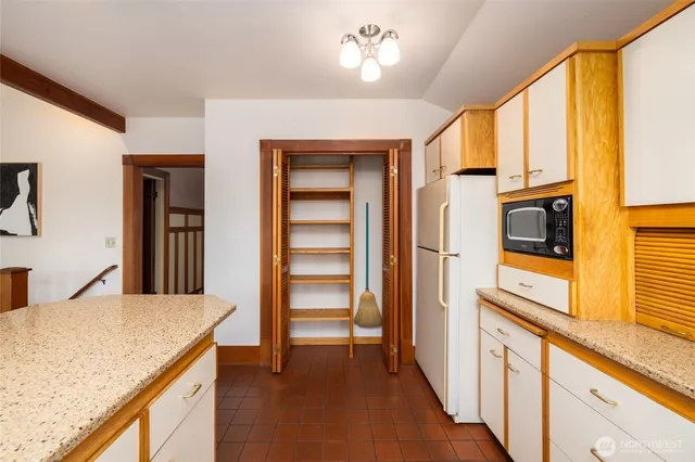 a kitchen with stainless steel appliances granite countertop a refrigerator and microwave