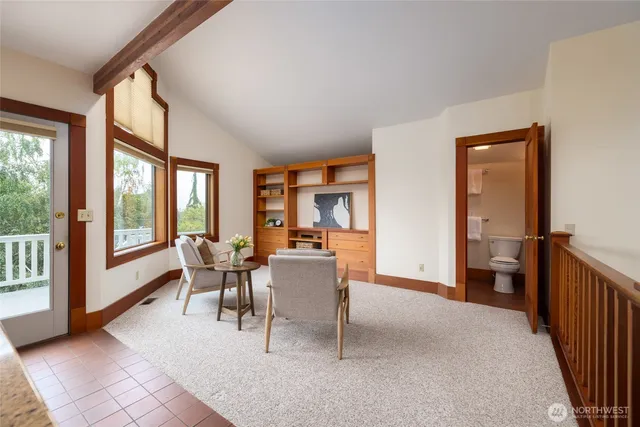 a dining room with furniture and large windows