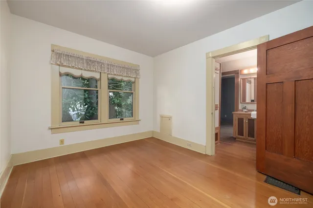 an empty room with windows and entrance