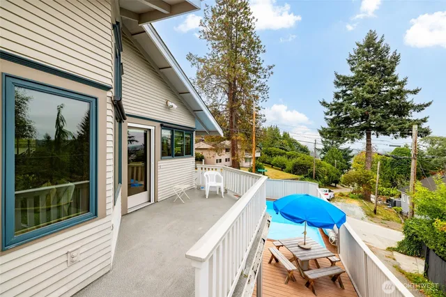 a view of a patio with couches table and chairs and potted plants