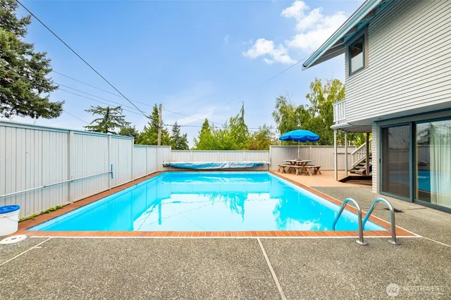 a view of a swimming pool with a lounge chairs
