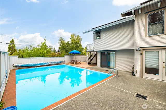a view of a swimming pool with an outdoor seating
