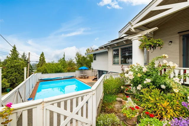 a view of an house with backyard and sitting area
