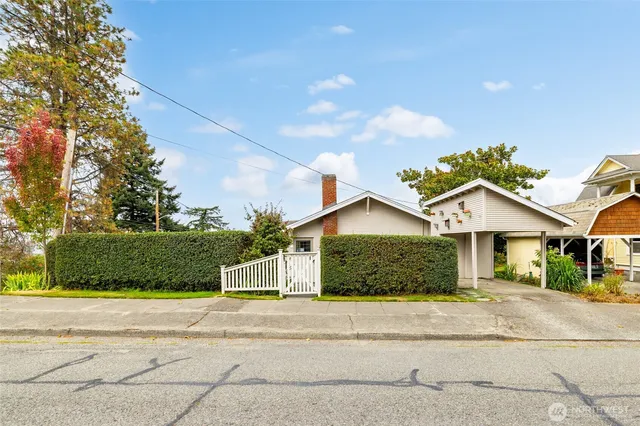 a front view of a house with a garden